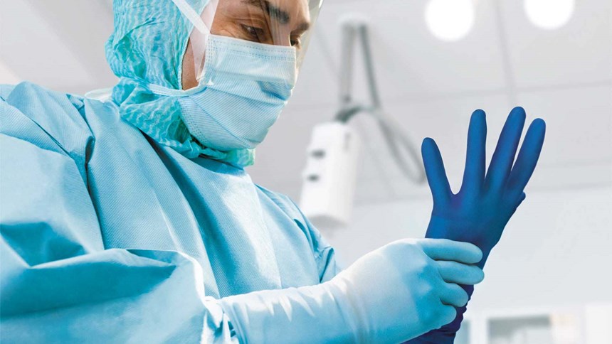 Kirurger som använder Biogel-handskar med punktionsindikering