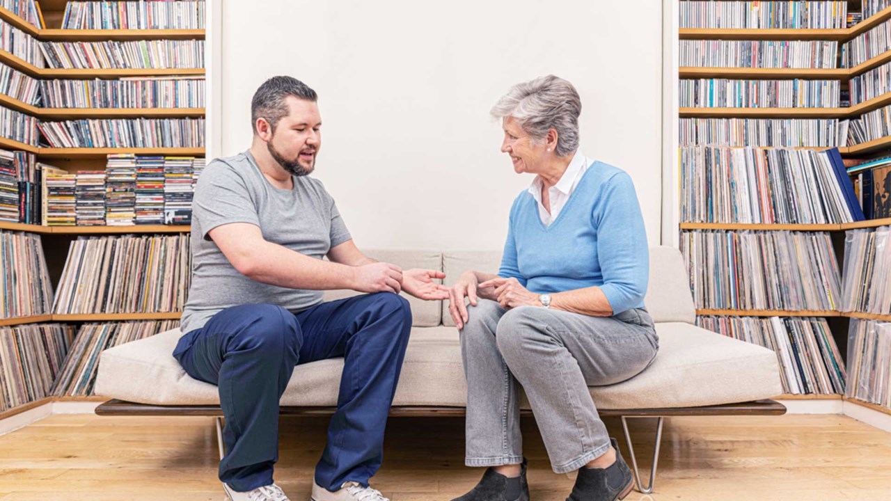 HCP checking up old lady's hand